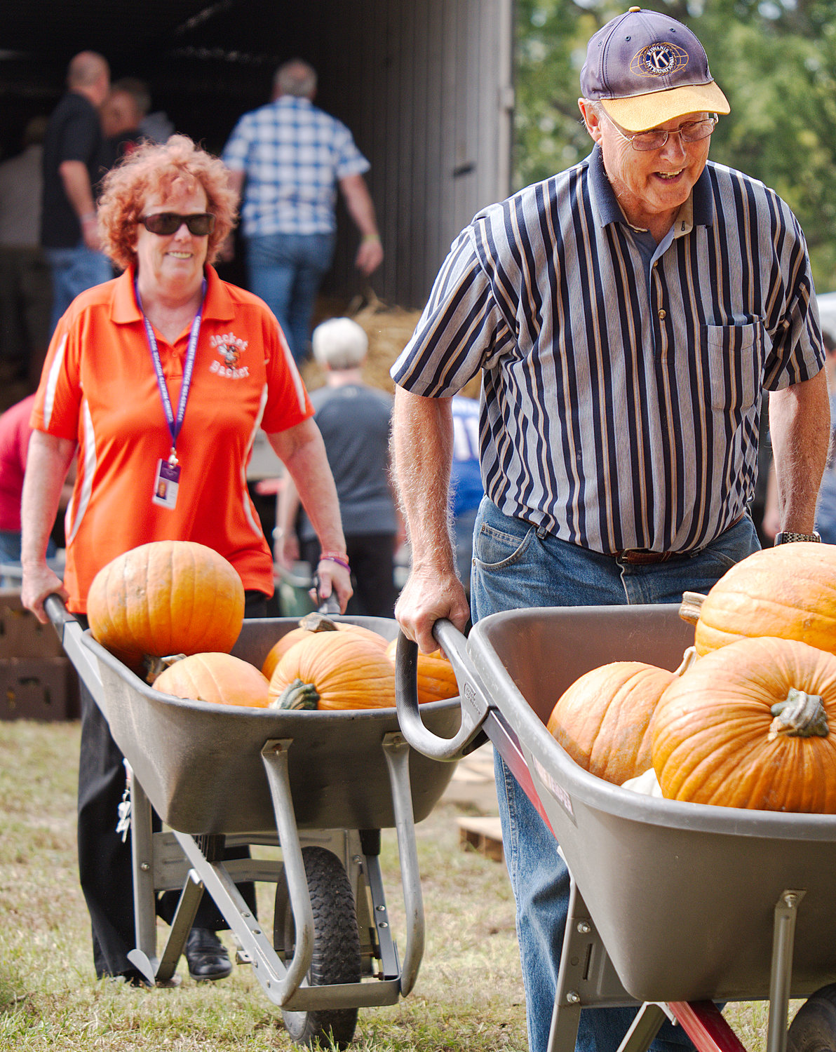 Sandy Bennett and Sam Curry wheel pumpkins from a truck at the First United Methodist Church in Mineola Monday in preparation for the church’s annual pumpkin patch, which raises money for various children’s ministries.